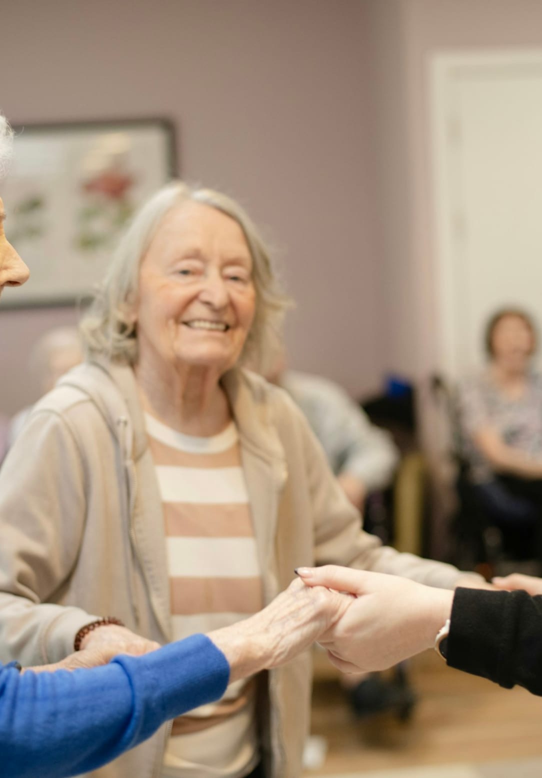 A care coordinator greeting a senior client warmly