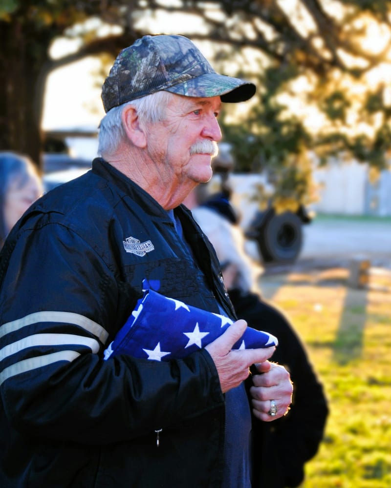 A senior veteran holding the American flag